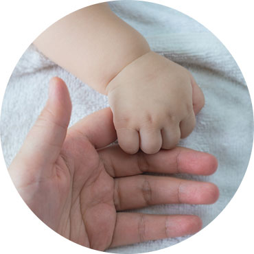 baby's hand holding finger